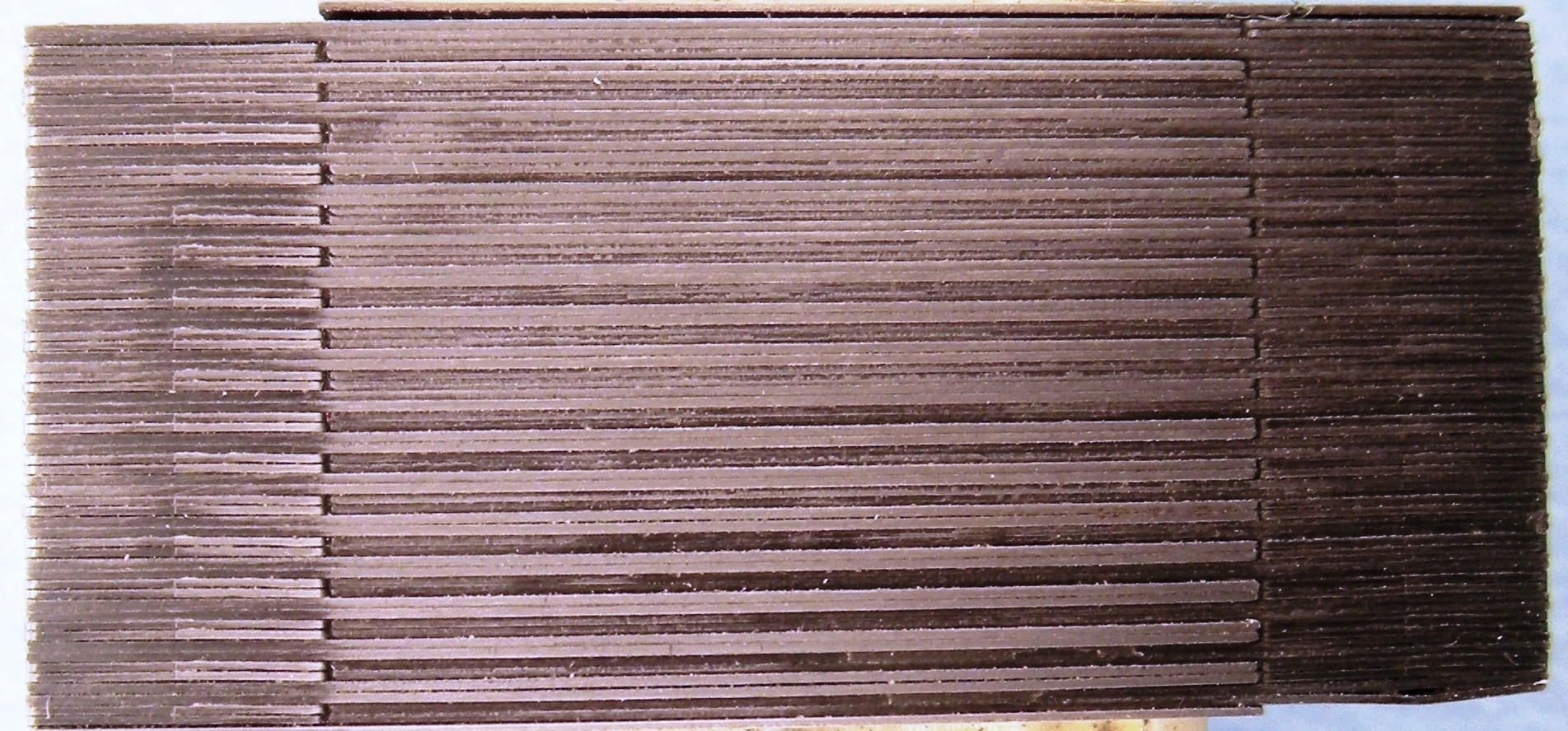 Stacked E-I electrical steel laminations showing separate sheet layers